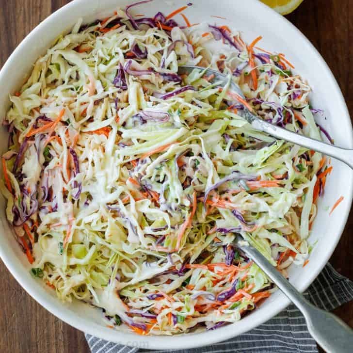 Coleslaw in a mixing bowl with creamy dressing