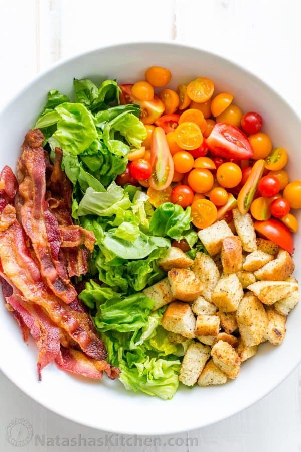 A BLT Salad loaded with fresh lettuce, crispy bacon, bright tomatoes, crunchy croutons and the BLT Salad dressing is exceptional. Easy, excellent salad! | natashaskitchen.com
