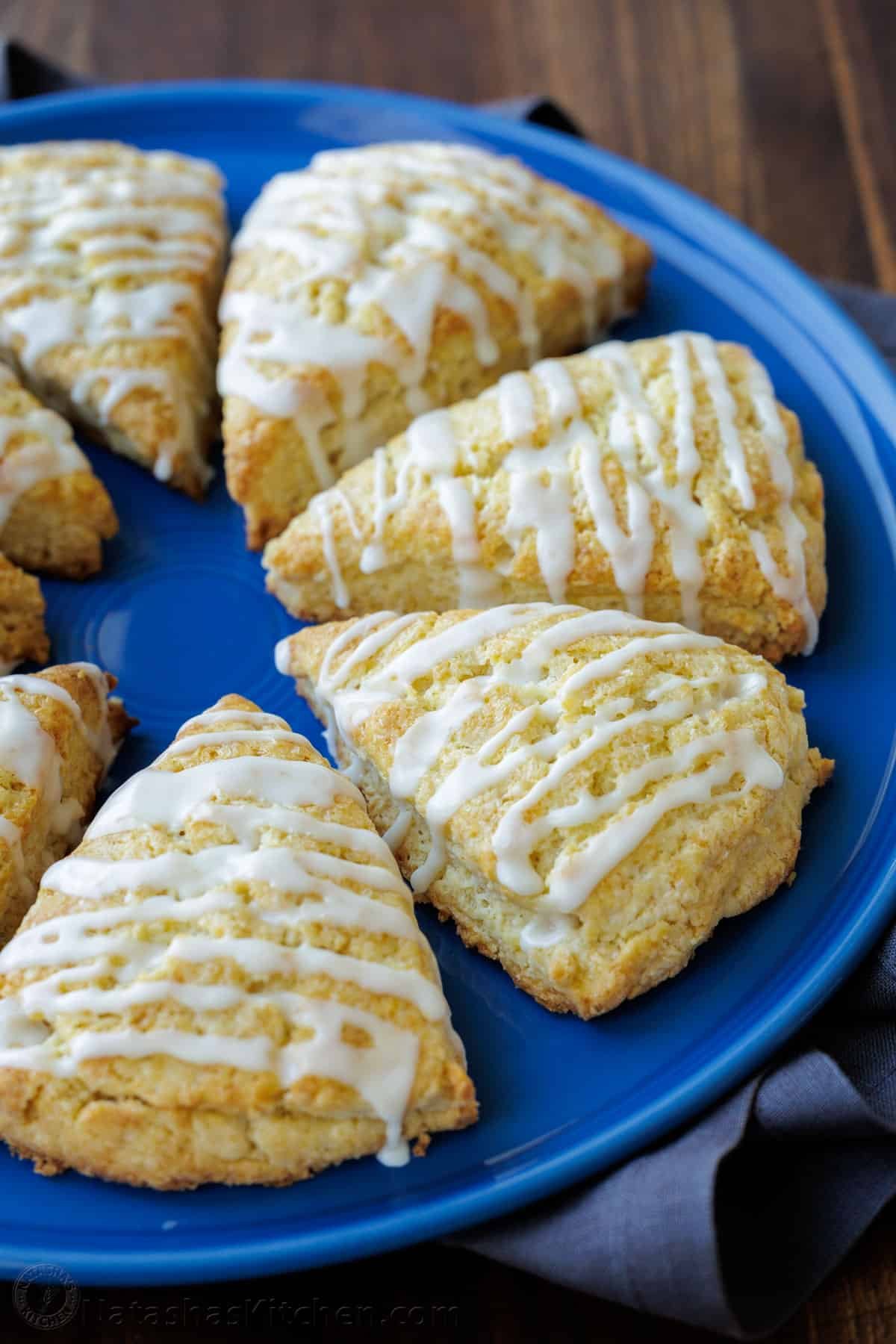 This classic Scone recipe is the perfect base for any homemade scones. Create delicious variations that will rival your favorite coffee shop scones. Classic scones arranged on a plate, drizzled with vanilla glaze
