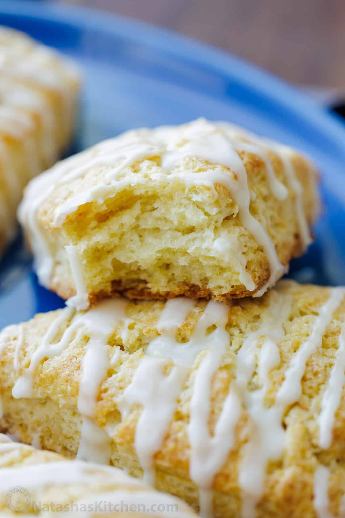 This classic Scone recipe is the perfect base for any homemade scones. Create delicious variations that will rival your favorite coffee shop scones. Flaky, soft textured scones on a plate, drizzled with vanilla glaze.