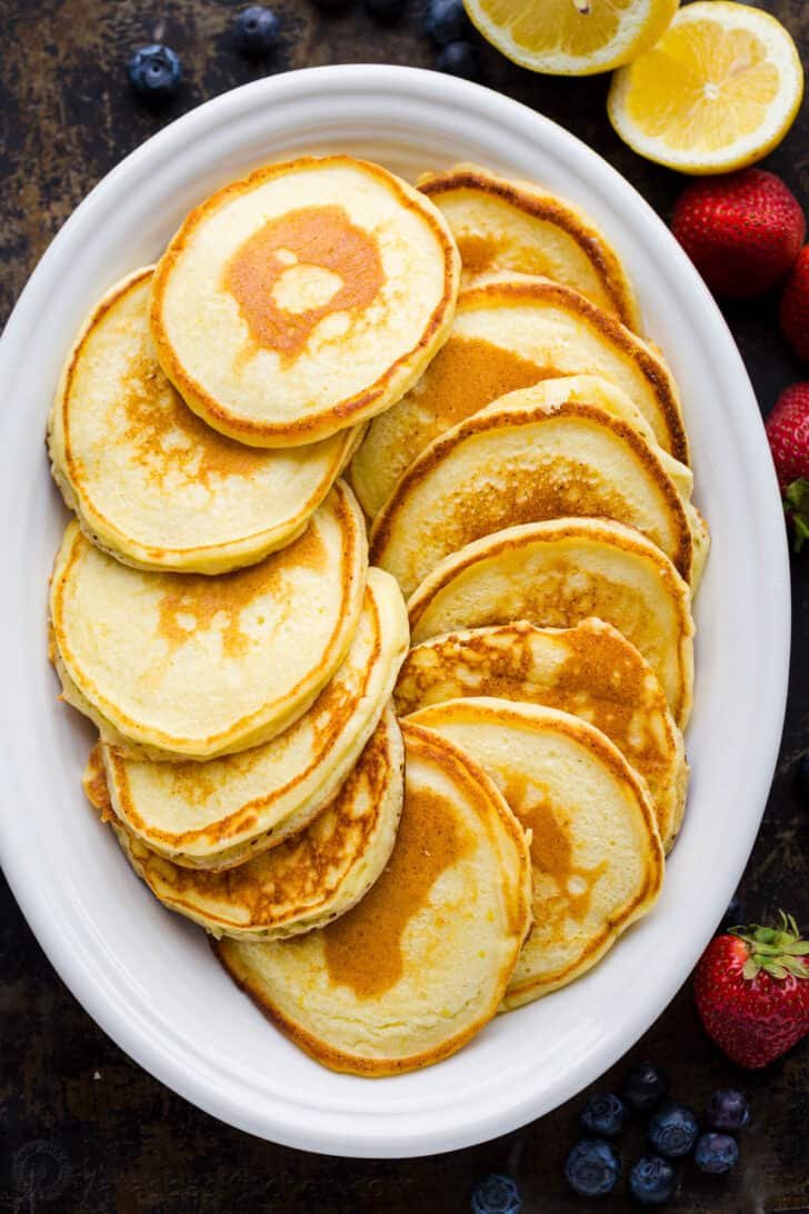 Cooked lemon ricotta pancakes on a serving platter