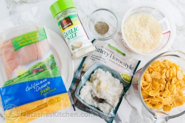 Ingredients for homemade chicken nuggets with chicken breast, potato flakes, corn flakes, parmesan cheese, garlic salt and pepper. 
