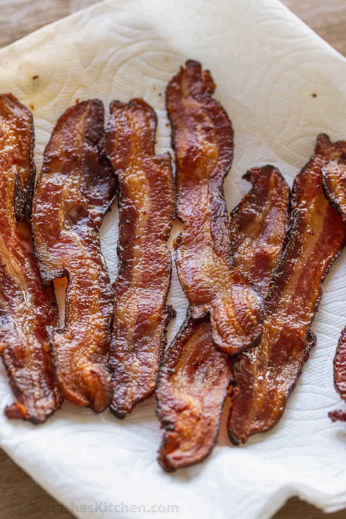 How to bake bacon in the oven that is perfectly crispy. Oven-baked bacon is the best for making a bigger batch and it's the easiest method. how to drain meat grease using a paper towel