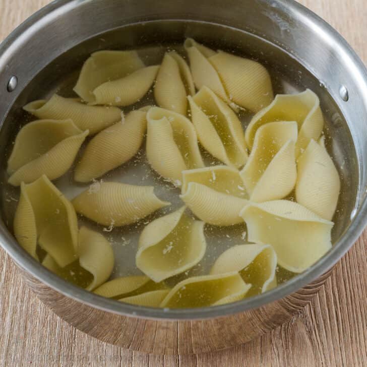 Cooking pasta shells in pot of water