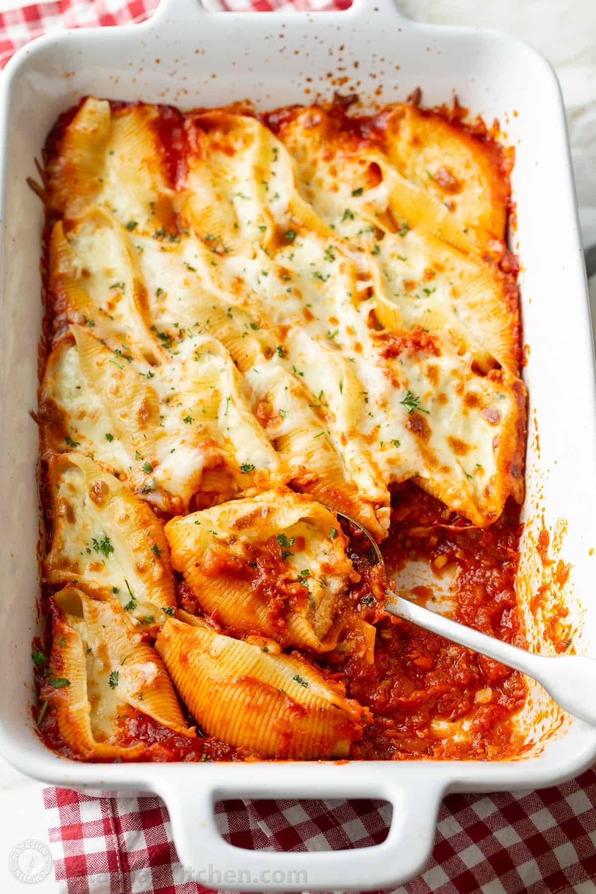 Stuffed Shells filled with ricotta, parmesan, and melty mozzarella cheese. Stuffed Pasta Shells always disappear fast and reheat well. Leftover baked stuffed pasta shells ready to be stored