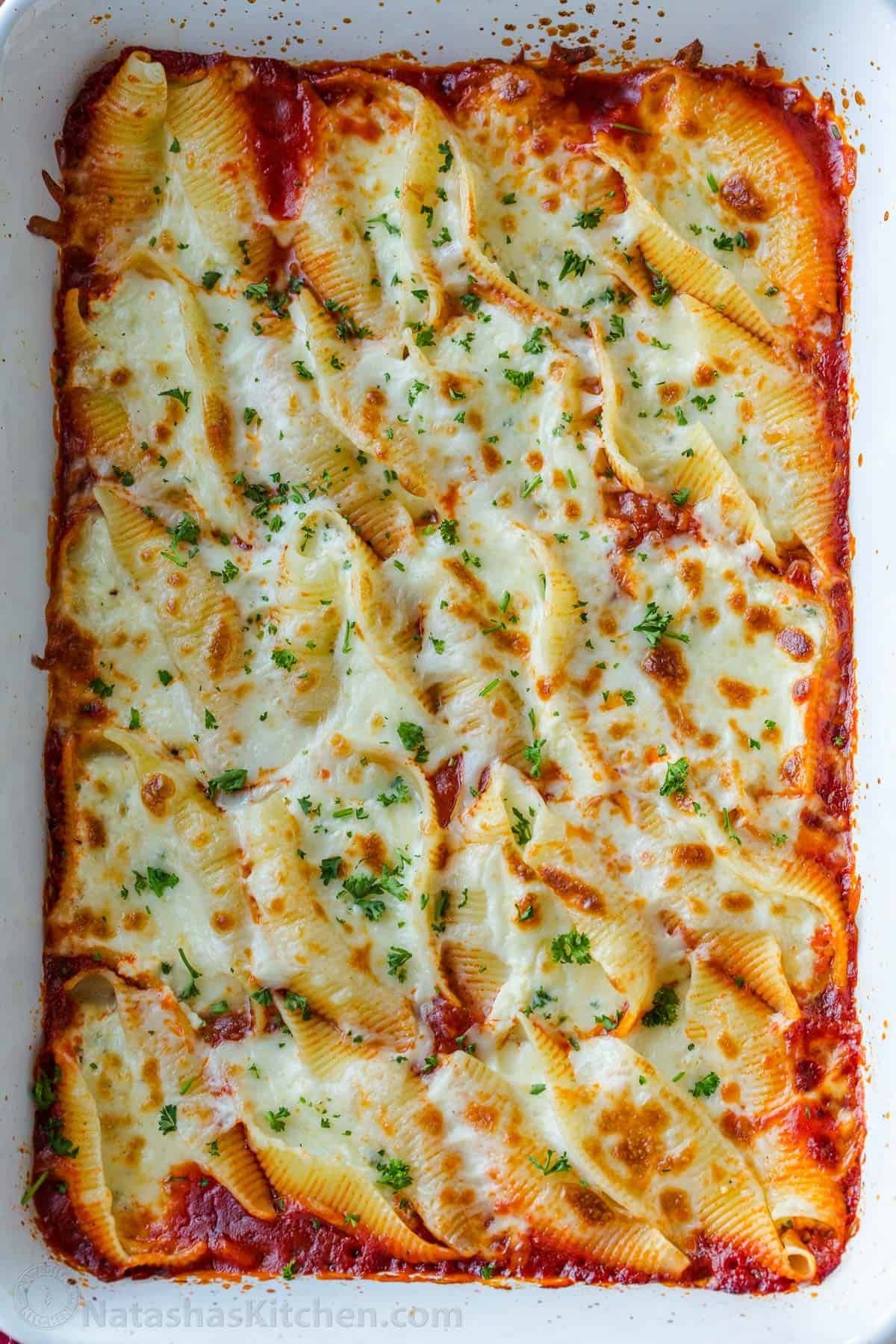 Stuffed Shells filled with ricotta, parmesan, and melty mozzarella cheese. Stuffed Pasta Shells always disappear fast and reheat well. Baked Stuffed Shells with ricotta in casserole