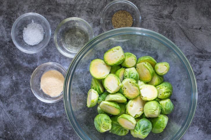 The easiest recipe for Air Fryer Brussels Sprouts, ready in less than 30 minutes. Crispy on the outside, soft and flavorful on the inside. Brussels Sprouts Ingredients with seasonings and oil
