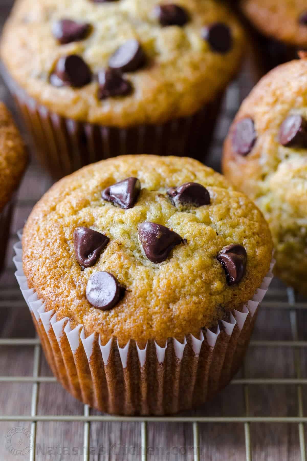 Easy Banana Muffins with chocolate chips are the ultimate treat. Our best banana chocolate chip muffins are a great way to use ripe bananas! Moist Banana bread muffins studded with chocolate chips on wire rack