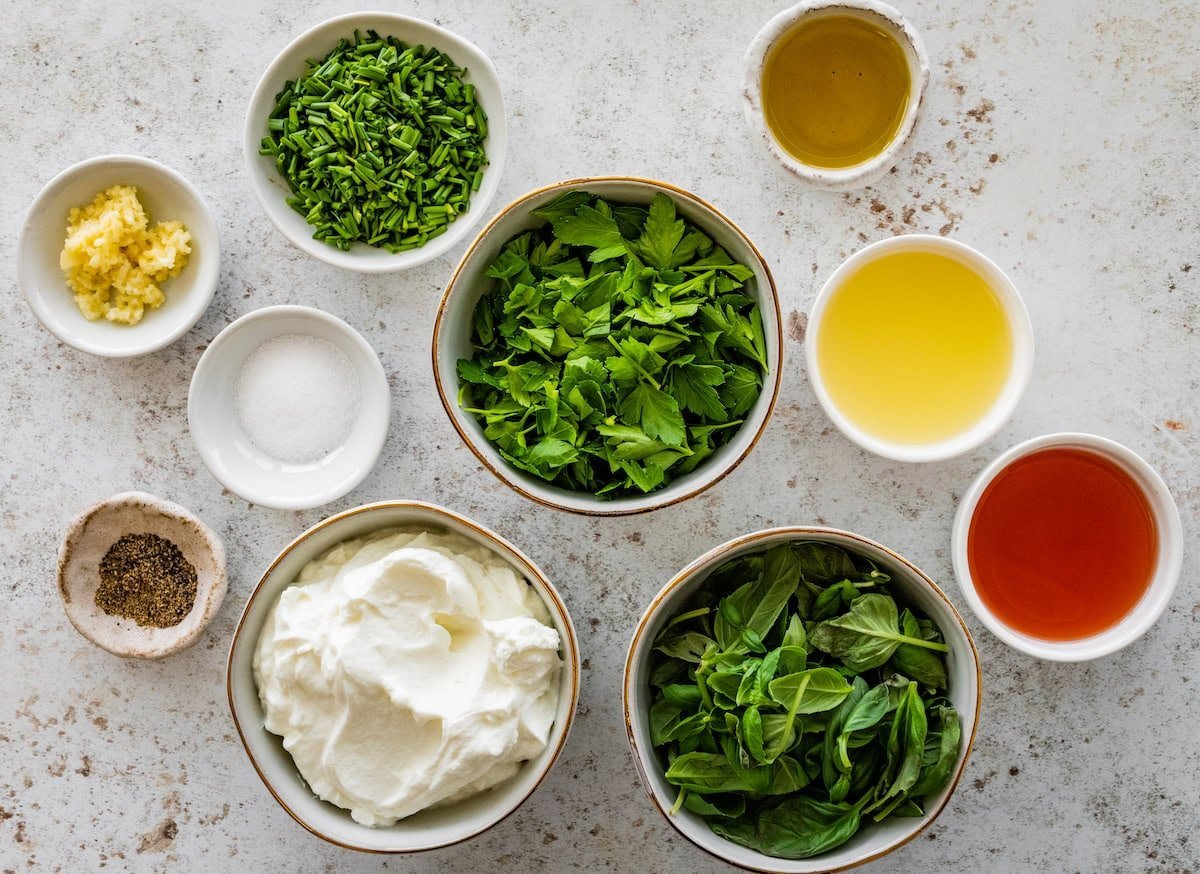 ingredients in bowls to make green goddess dressing.