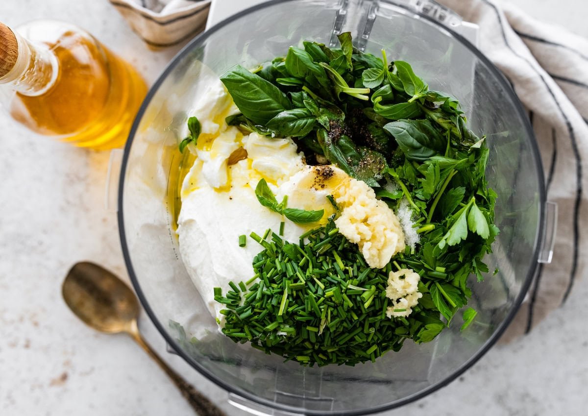 fresh herbs, garlic, Greek yogurt, olive oil in food processor to make green goddess dressing.