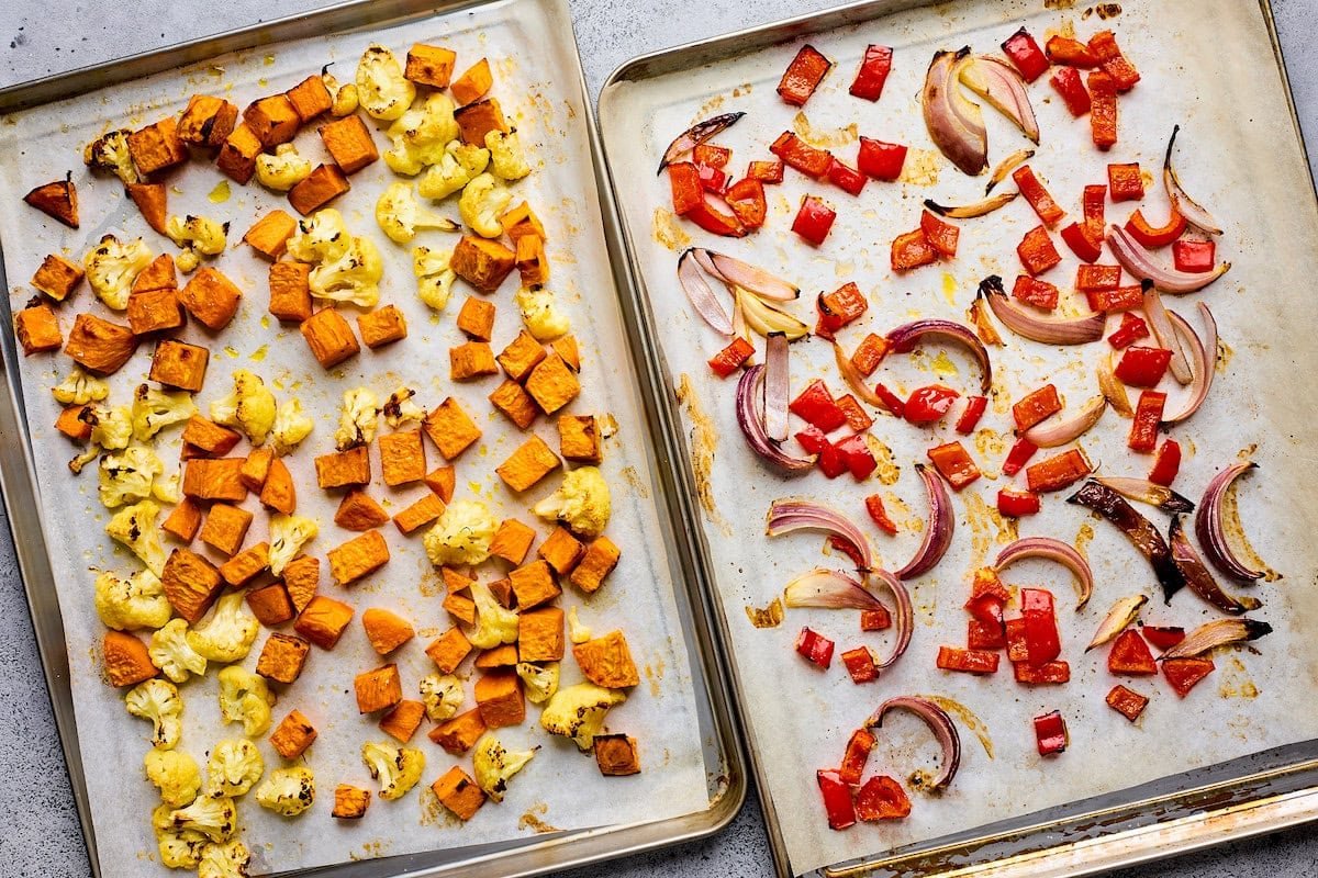 roasted vegetables on baking sheets with parchment paper.