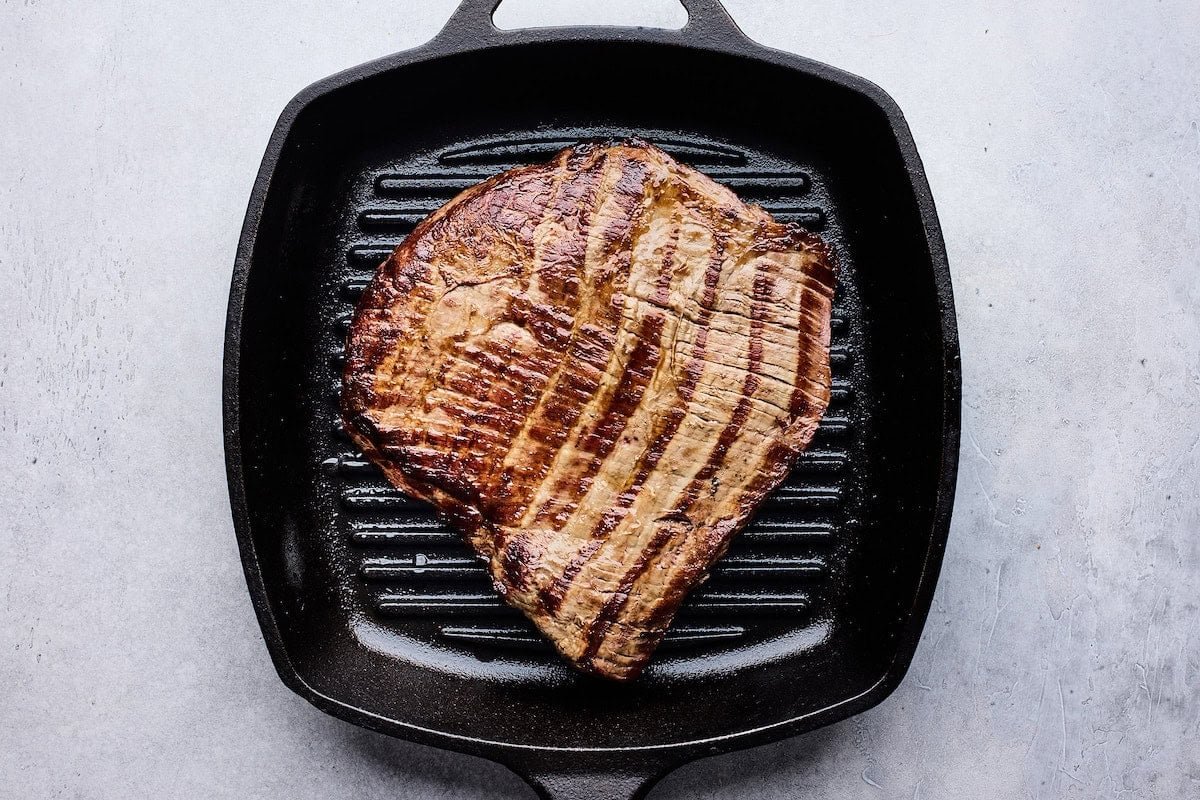 steak grilling on grill pan.