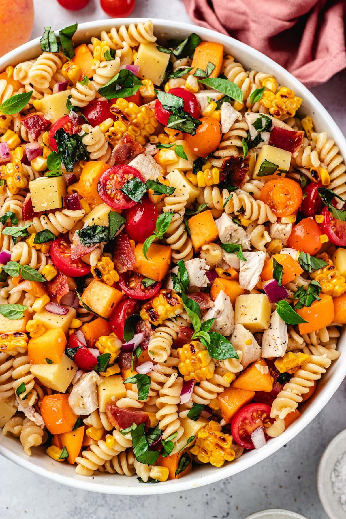 close up of chicken bacon peach pasta salad with hot honey dressing.