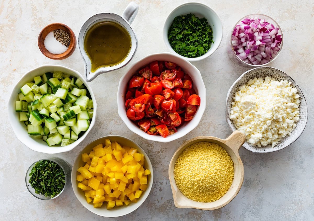 ingredients in bowls to make couscous salad.