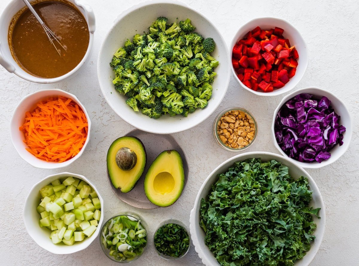 fresh vegetables in bowls to make chopped kale broccoli salad.