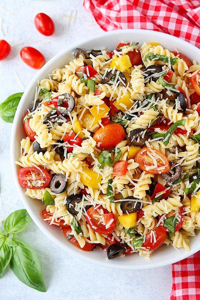 This Easy Pasta Salad is perfect for summer potlucks, parties, and picnics. It is SO easy to make and always a hit! #pasta #pastasalad #summer #vegetarian #easyrecipe #vegetarianrecipe #sidedish Easy Pasta Salad in white serving bowl.