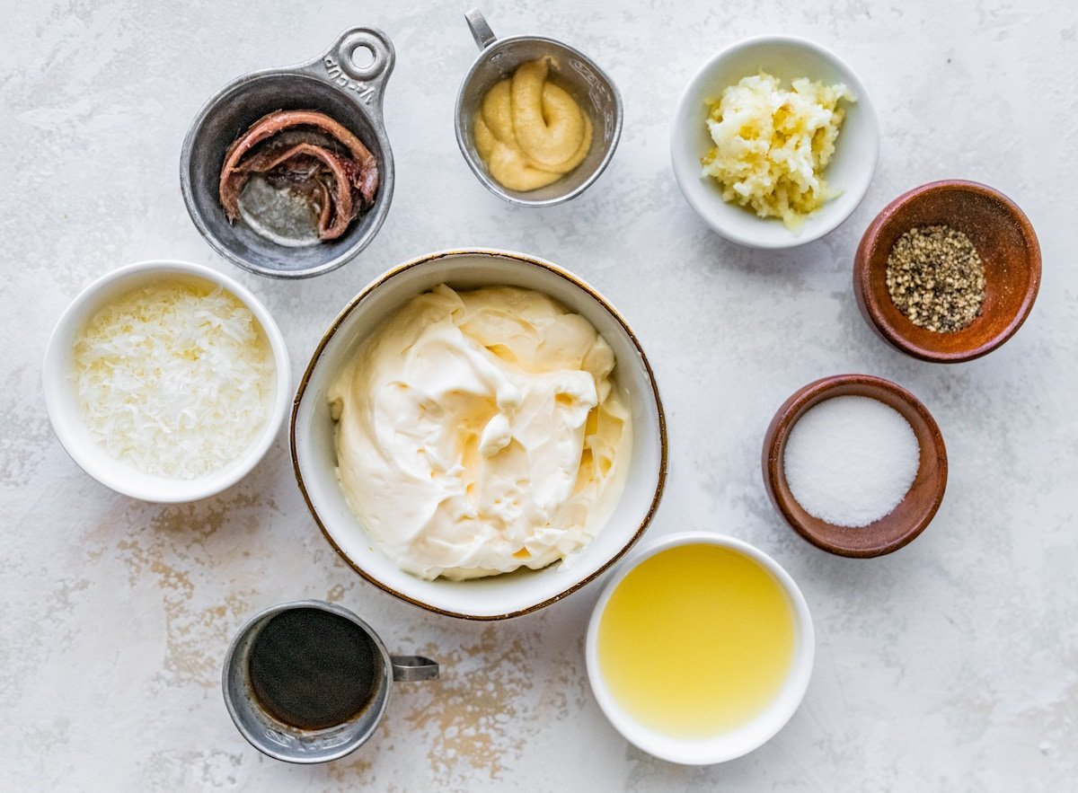 caesar dressing ingredients in bowls.