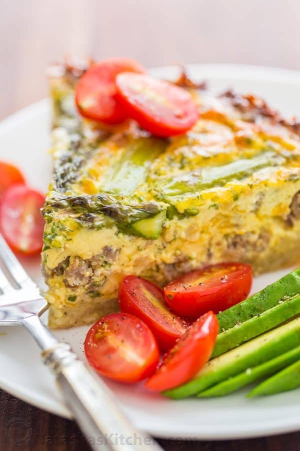 Every bite of this Sausage Asparagus Quiche is pure comfort. This classic quiche recipe is loaded with juicy sausage, eggs, fresh asparagus and herbs. | natashaskitchen.com