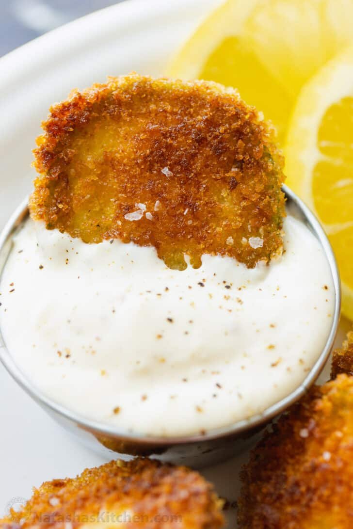 Dipping zucchini crisp into garlic aioli sauce