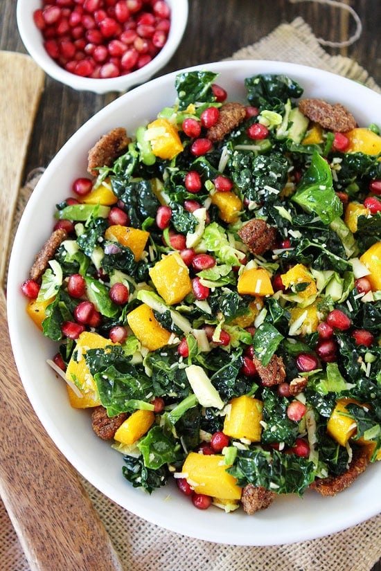 Kale and Brussels Sprouts Salad with Butternut Squash, Pomegranate, and Candied Pecans Recipe on twopeasandtheirpod.com 