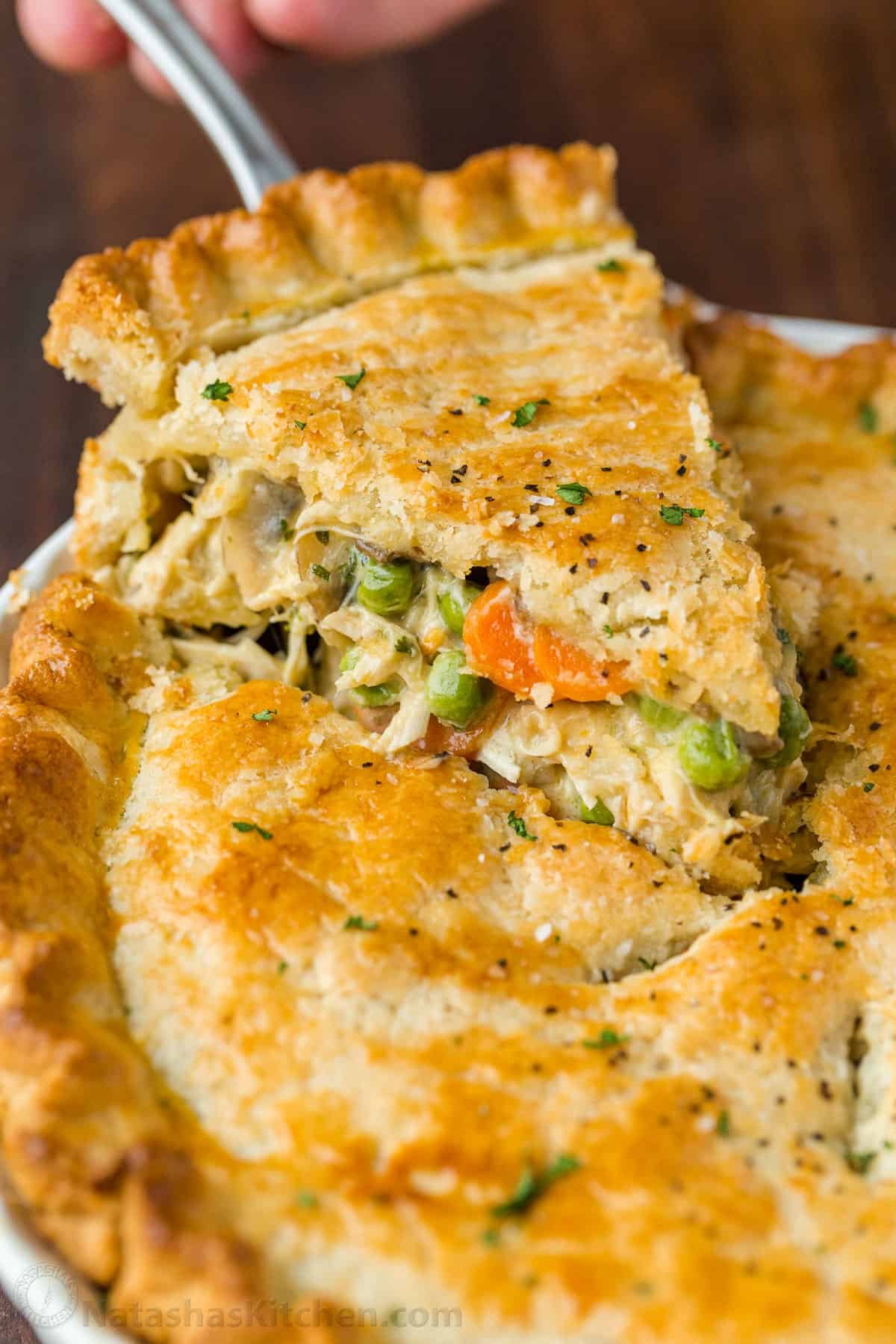 Baked Chicken Pot pie with a slice on a pie server
