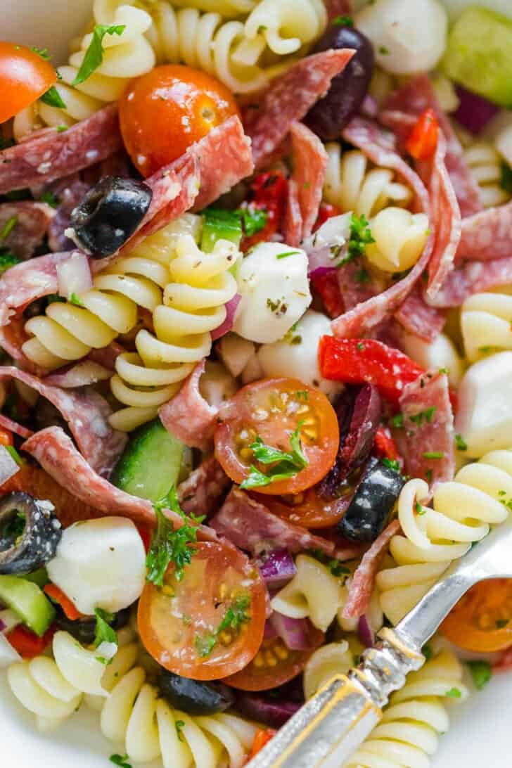 Pasta Cooked until aldente for pasta salad in bowl combined with other pasta salad ingredients