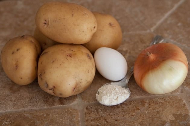 Ingredients for deruny, Ukrainian potato pancakes on the table 