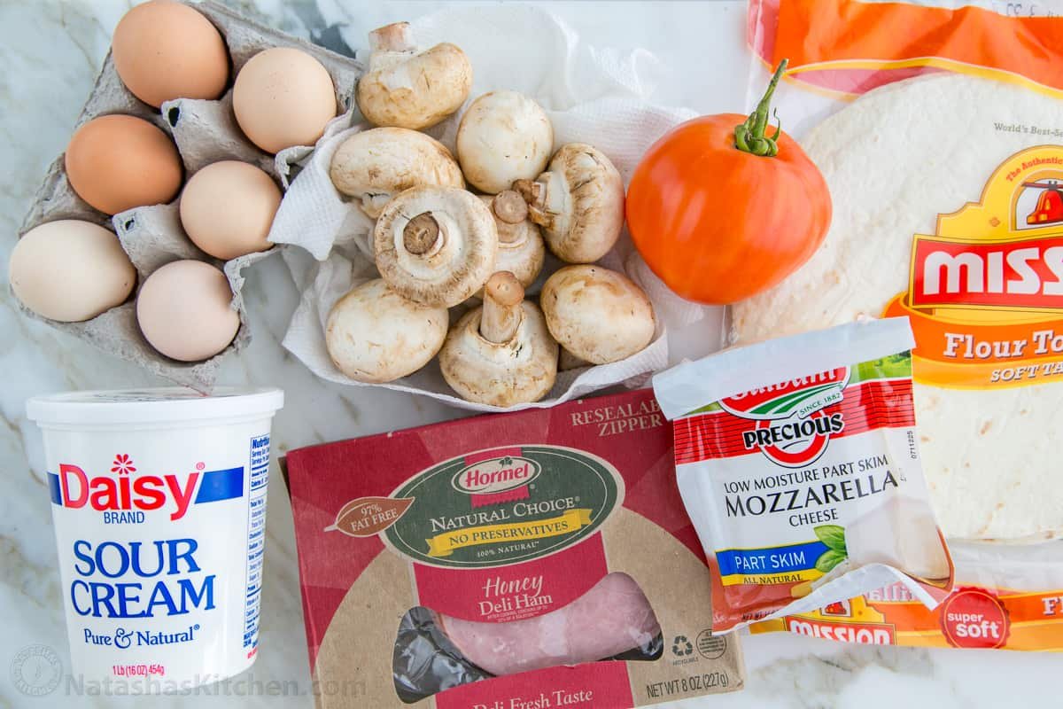 How to make Breakfast Burritos What's in a breakfast burrito? Eggs, sour cream, ham, cheese, tomato, mushroom, wrapped in a tortilla