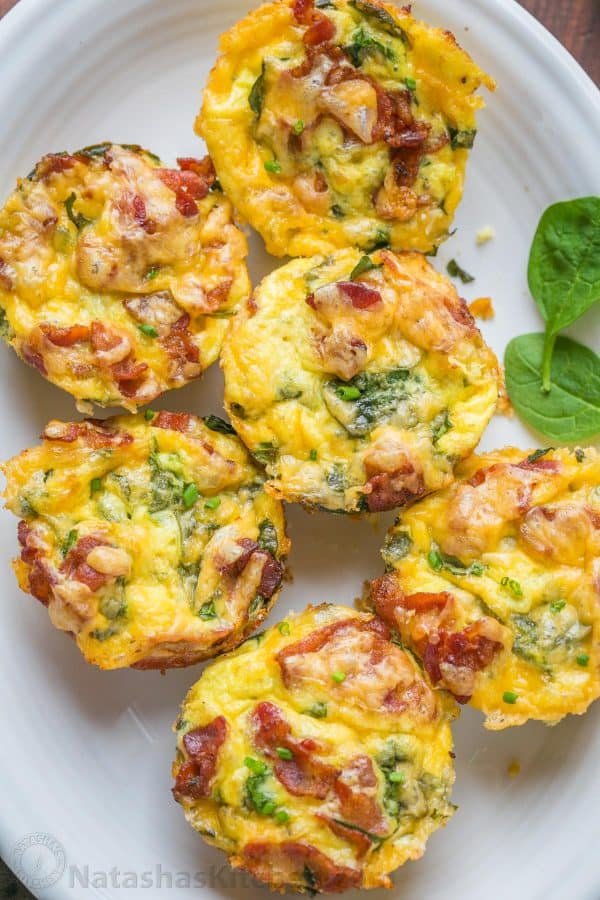Breakfast casserole muffins come together quickly. Loaded with potato, spinach, eggs, cheese and crisp bacon. Freezer friendly make-ahead breakfast muffins! | natashaskitchen.com
