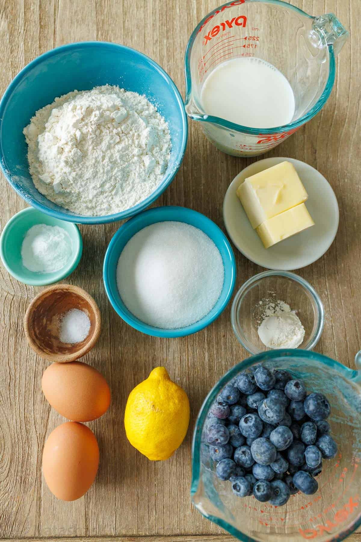 Ingredients for lemon blueberry bread. Ingredients for Blueberry Lemon Bread measured out. Blueberries, lemon, eggs, flour, sugar, butter, milk, baking powder, salt, vanilla