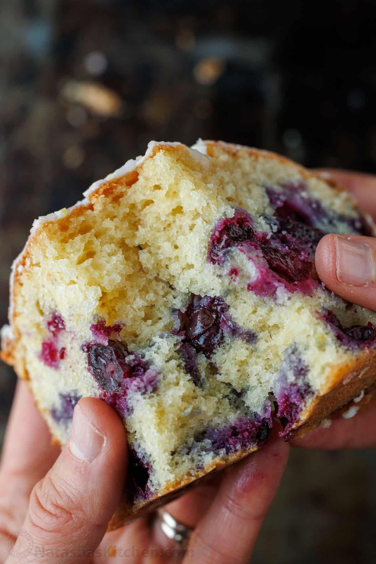 This Lemon Blueberry Bread has a moist and tender crumb and is loaded with blueberries. Don't skip the lemon glaze - you'll love every bite! Loaf of Blueberry Bread with Lemon glaze sliced