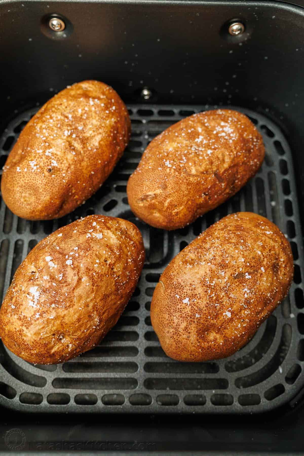 My easy Air Fryer Baked Potato recipe makes the best Baked Potatoes. You'll love the crispy skin with a soft and fluffy center in less time! Air Fryer Potatoes perfectly cooked in air fryer basket