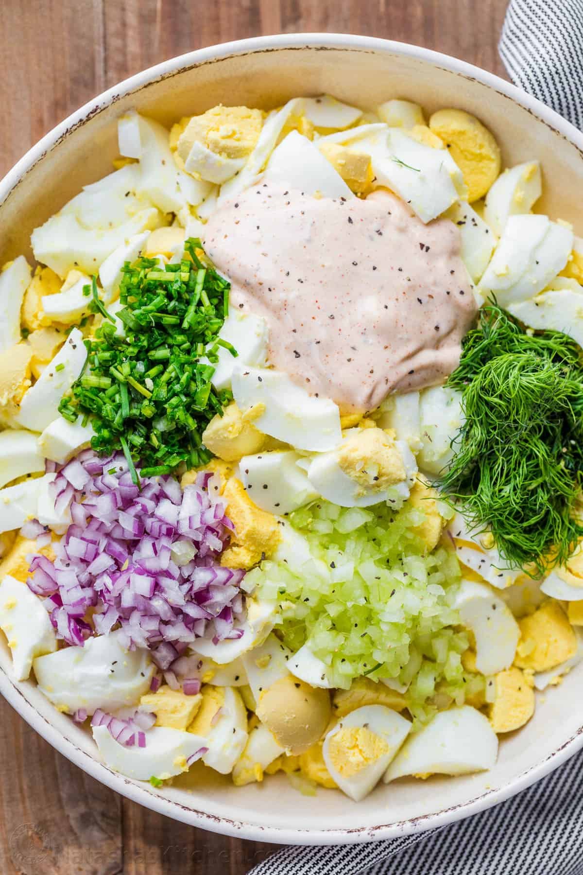 Truly the Best Egg Salad Recipe. Hard-boiled eggs with celery, dill, seasoning and chives in creamy dressing. Egg salad is a great way to use cooked eggs! How to make egg salad in a mixing bowl with the dressing