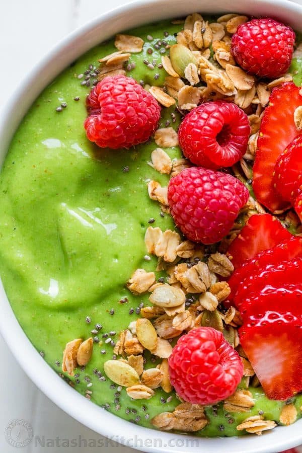 smoothie bowl served with granola and fresh berries over the top and chia seeds