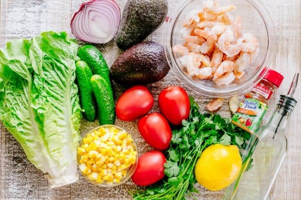 We could live off this shrimp avocado salad. It's crazy good and loaded with avocado, cucumbers, tomatoes, sweet corn and tossed with a light and easy cilantro-lemon dressing. This shrimp salad has all the best flavors of summer! WINNER!! | natashaskitchen.com