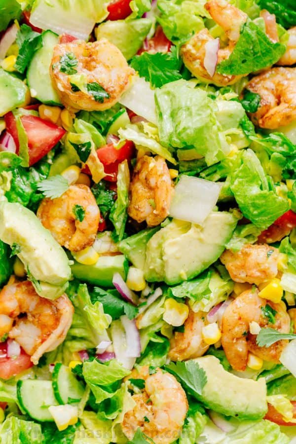 We could live off this shrimp avocado salad. It's crazy good and loaded with avocado, cucumbers, tomatoes, sweet corn and tossed with a light and easy cilantro-lemon dressing. This shrimp salad has all the best flavors of summer! WINNER!! | natashaskitchen.com