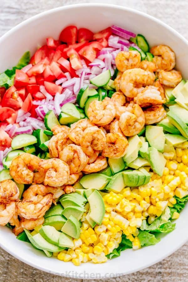We could live off this shrimp avocado salad. It's crazy good and loaded with avocado, cucumbers, tomatoes, sweet corn and tossed with a light and easy cilantro-lemon dressing. This shrimp salad has all the best flavors of summer! WINNER!! | natashaskitchen.com