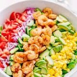 We could live off this shrimp avocado salad. It's crazy good and loaded with avocado, cucumbers, tomatoes, sweet corn and tossed with a light and easy cilantro-lemon dressing. This shrimp salad has all the best flavors of summer! WINNER!! | natashaskitchen.com