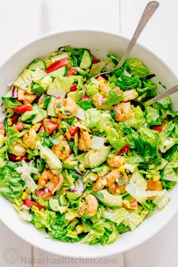 We could live off this shrimp avocado salad. It's crazy good and loaded with avocado, cucumbers, tomatoes, sweet corn and tossed with a light and easy cilantro-lemon dressing. This shrimp salad has all the best flavors of summer! WINNER!! | natashaskitchen.com