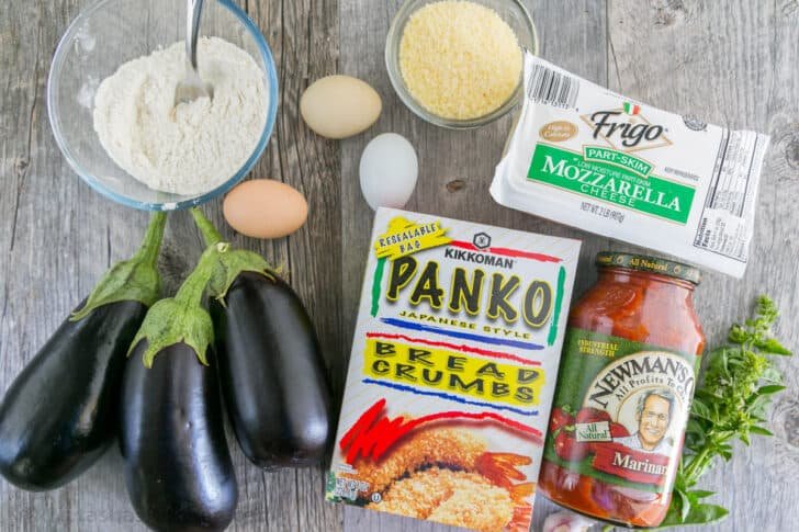 This Baked Eggplant Parmesan recipe fills your mouth with crisp eggplant, flavorful marinara, and plenty of melted cheese to replicate a classic Italian dish. Ingredients for eggplant parmesan with eggplant, panko crumbs, parmesan, eggs, marinara, flour, and mozzarella