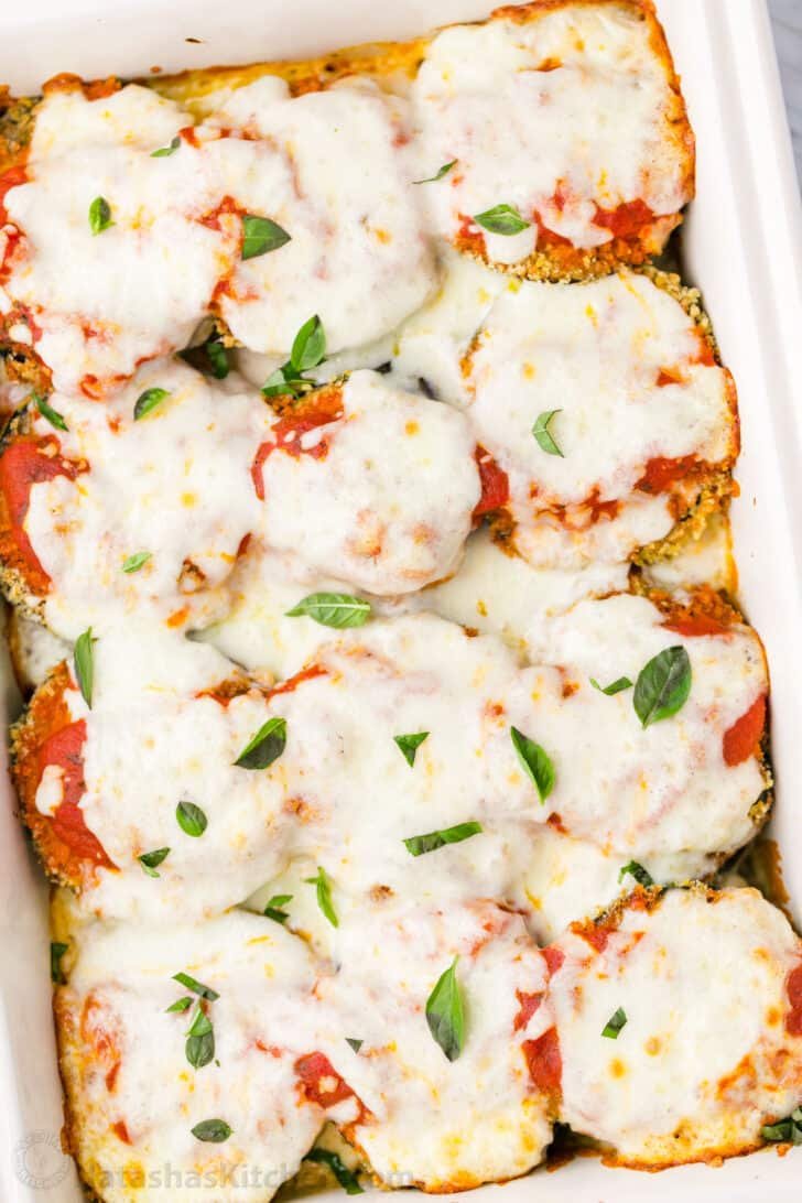 This Baked Eggplant Parmesan recipe fills your mouth with crisp eggplant, flavorful marinara, and plenty of melted cheese to replicate a classic Italian dish. Mouthwatering Eggplant Parmesan