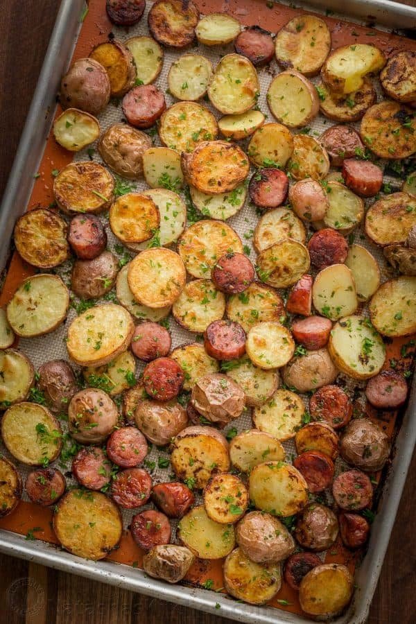 These roasted potatoes are ultra crispy and flavorful with a perfect browning on the coins of kielbasa. Easy, one-pan roasted potatoes and sausage recipe | natashaskitchen.com
