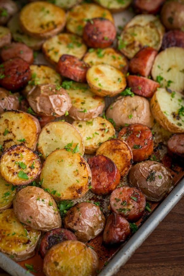 These roasted potatoes are ultra crispy and flavorful with a perfect browning on the coins of kielbasa. Easy, one-pan roasted potatoes and sausage recipe | natashaskitchen.com