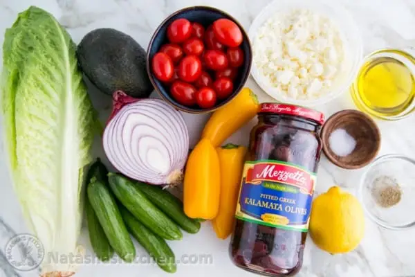 Fresh Greek Salad is a must try! So healthy with cucumber, tomato, avocado, olives and feta. You will want the easy Greek dressing on all of your salads! #greeksalad #greeksaladdressing #greekdressing #greekrecipes #salad #avocado #natashaskitchen Ingredients for Greek Salad with cucumbers, tomatoes, kalamata olives and feta cheese