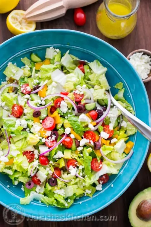 Fresh Greek Salad is a must try! So healthy with cucumber, tomato, avocado, olives and feta. You will want the easy Greek dressing on all of your salads! Salad made ahead before adding dressing