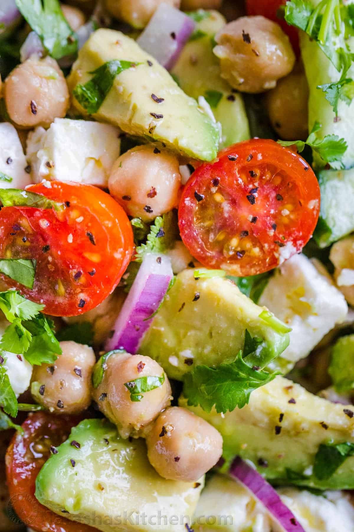 This Chickpea Salad is loaded with crisp cucumbers, juicy tomatoes, creamy avocado, feta, and chickpeas. You'll love the fresh lemon dressing! Chickpeas and garbanzo beans tossed with tomatoes, avocados, cucumber and red onion