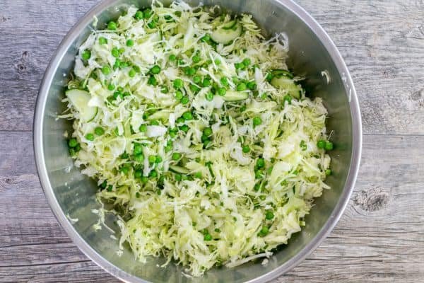 This cabbage and pea salad is vibrant, crisp and fresh. I love the sweet pop of flavor from the peas and the easy zesty dressing. A must try cabbage salad! | natashaskitchen.com