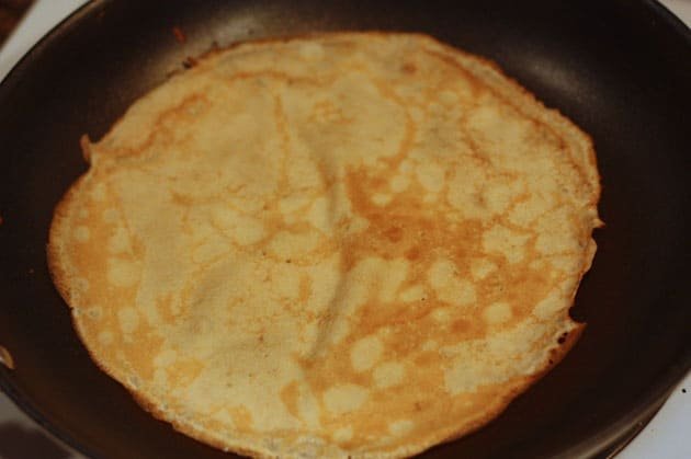 A crepe, nalesnik, on a skillet 