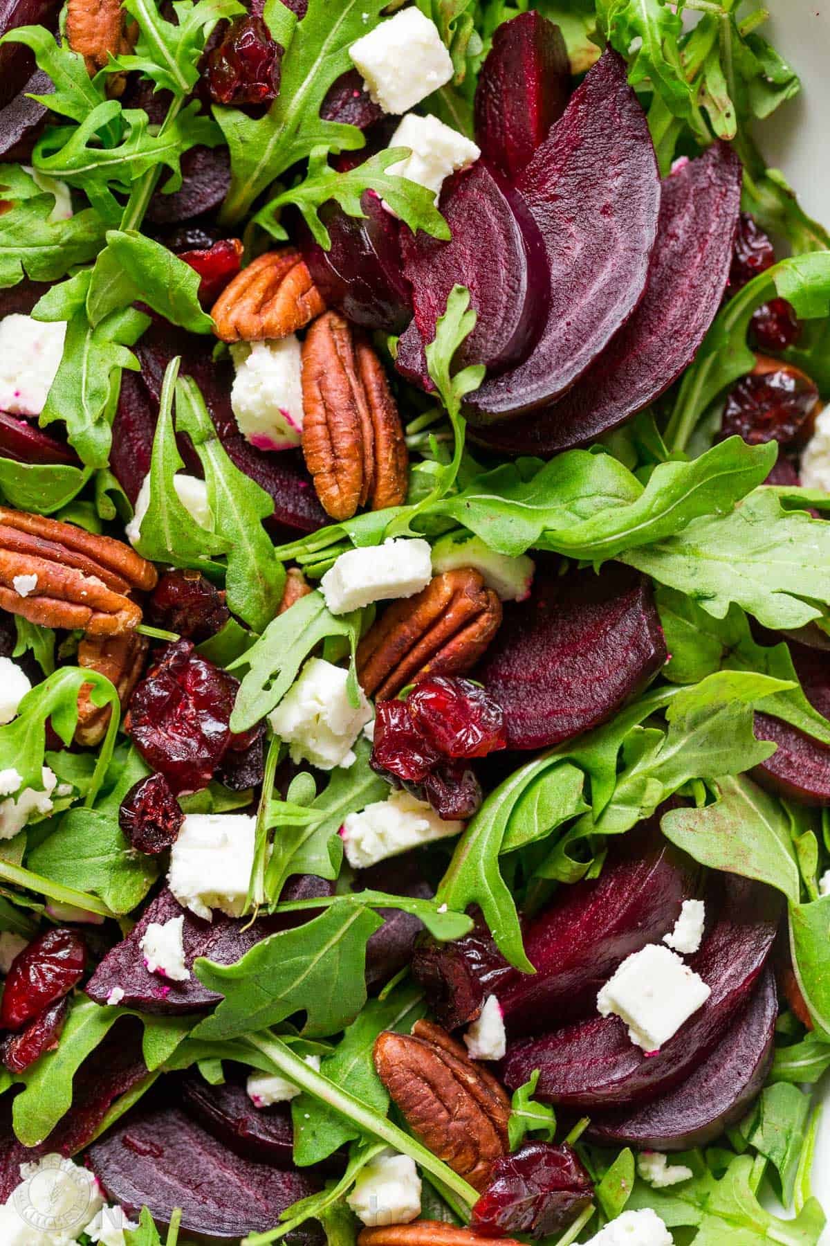 This beet salad recipe tastes fancy but is SO EASY to make. A show-stopping and flavorful salad that is impressive for holidays, entertaining, or dinner at home. Roasted beets on top of arugula lettuce with feta, pecans, and dried cranberries