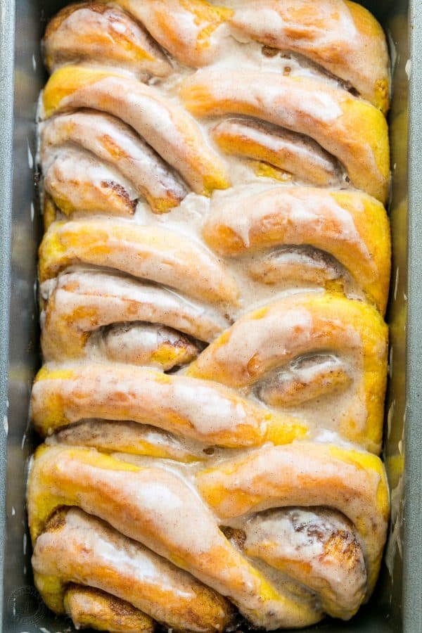 You'll make this Pumpkin Bread over and over. Cinnamon rolls + pumpkin pie + amazing cinnamon glaze = this pull-apart pumpkin bread! It melts in your mouth! | natashaskitchen.com